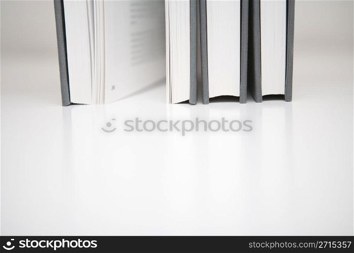 Three books in an abstract environment