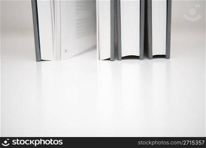Three books in an abstract environment
