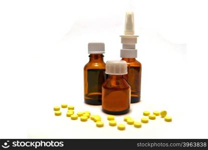 Three bottles of medication and pills on white background