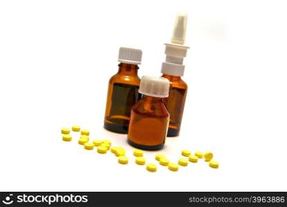 Three bottles of medication and tablets on white background