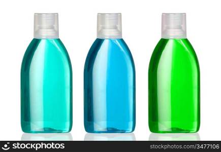 Three bottles of mouthwash with reflection on white background