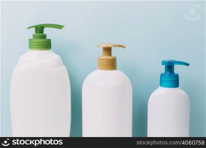 three bottles with bright pumps