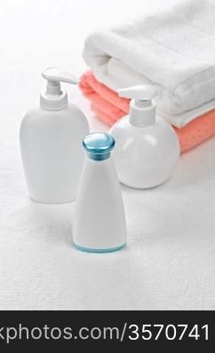 three bottles with two towels