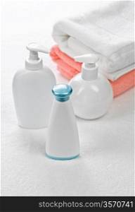 three bottles with two towels