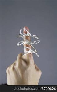 Three bows tied to a person&acute;s finger