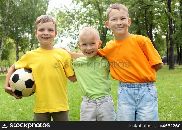 Three boys in the park with a ball
