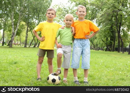 Three boys in the park with a ball