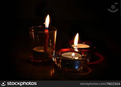 Three bright burning candles in the dark