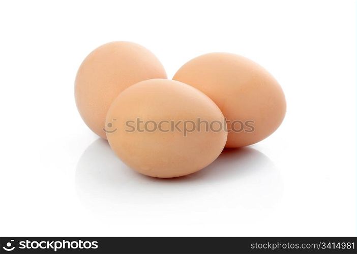 Three brown raw eggs isolated on white background