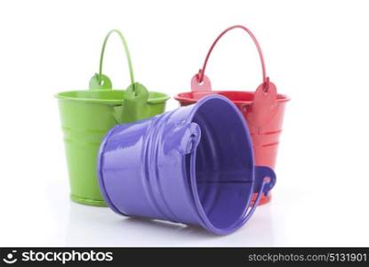 Three buckets of different colors, isolated on white background.