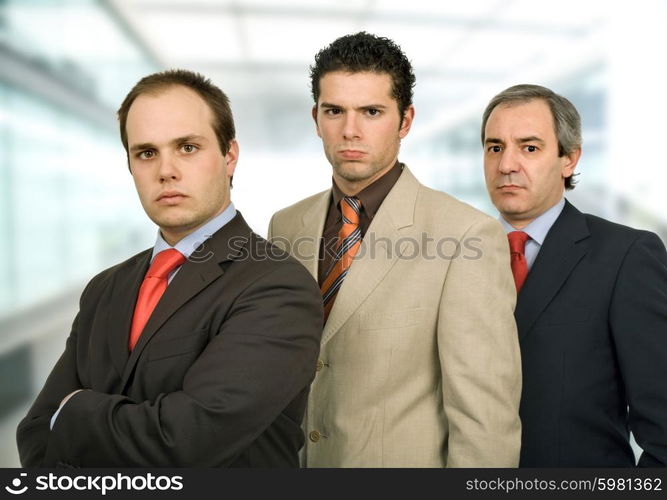 three business men standing at the office