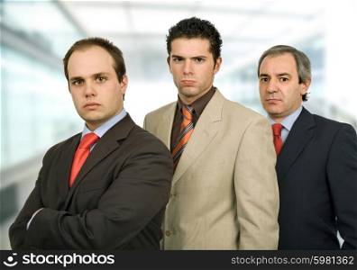 three business men standing at the office