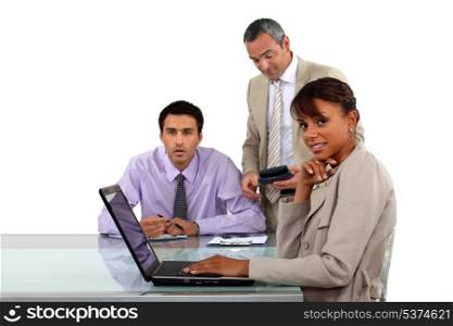 Three business people in meeting
