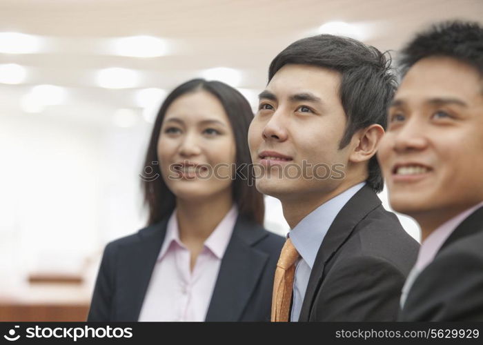 Three Business People Looking Away