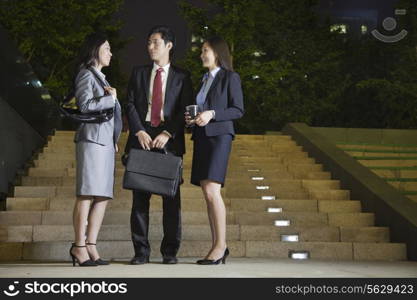 Three Business People Talking At Park