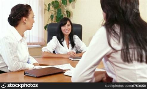Three Business Women are Discussing in a Meeting, Focus on Background