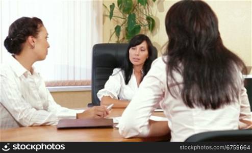Three Business Women are Discussing in a Meeting, Focus on Background