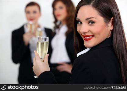 three business women drinking sparkling wine