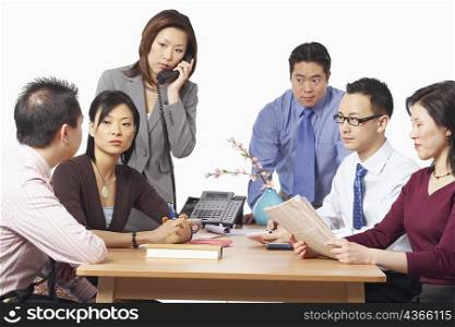 Three businessmen and three businesswomen in a meeting