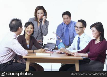 Three businessmen and three businesswomen in a meeting