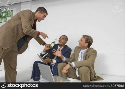 Three businessmen celebrating together