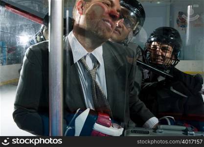 Three businessmen playing ice hockey