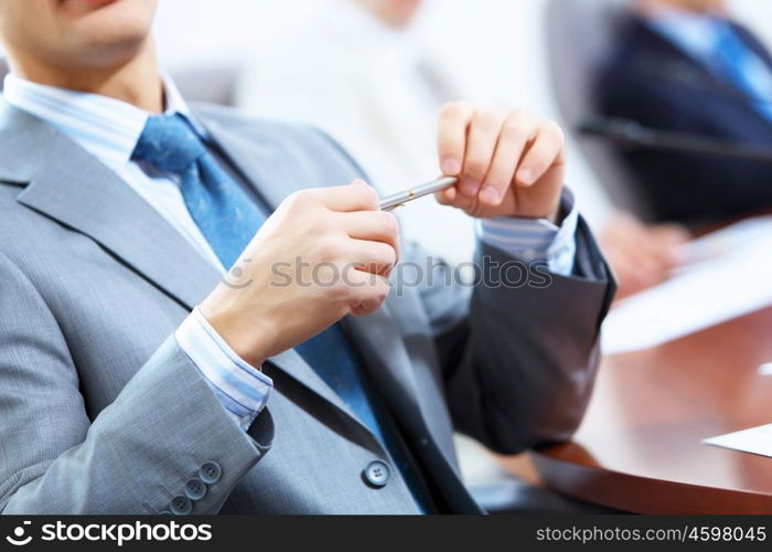 Three businesspeople at meeting. Image of three businesspeople at table at conference