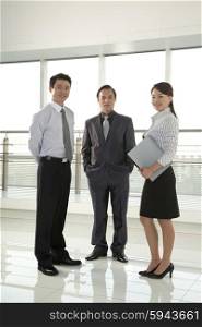 Three Businesspeople Looking at Camera