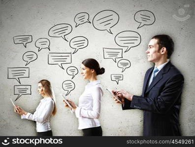 Three businesspeople with tablet pc in hands. Three young people with tablet pc in hands