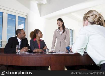 Three businesswomen and a businessman in an office