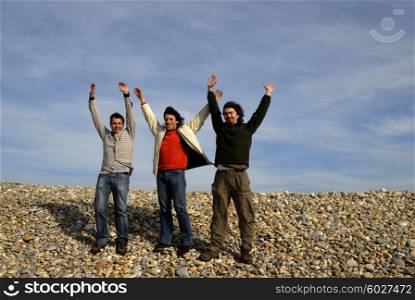 three casual young men at the beach
