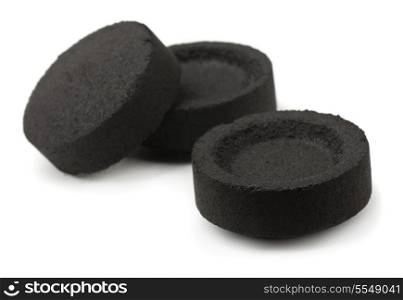 Three charcoal briquettes isolated on white