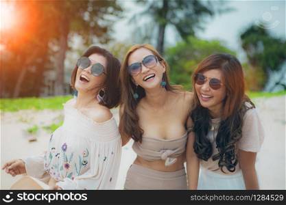 three cheerful asian woman happiness emotion on vacation sea beach