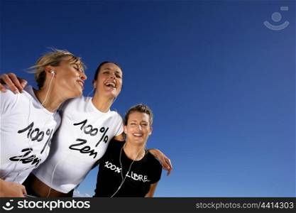 Three cheerful women listening to music