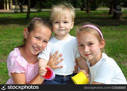 three children in park in summer