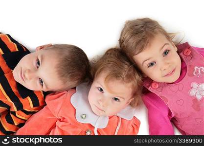 Three children lying top view close-up 2