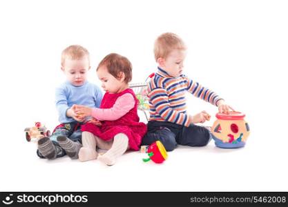 Three children play with toys isolated on white