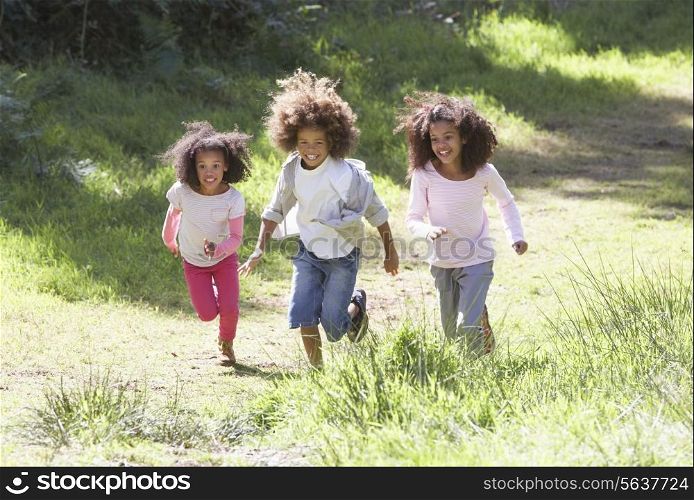 Three Children Playing In Woods Together