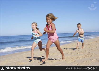 Three Children Running Along Beach