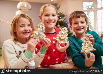 Three Children Showing Decorated Christmas Cookies