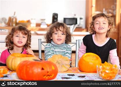 Three children with pumpkins