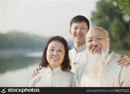 Three Chinese People With Tai Ji Clothes Smiling At Camera