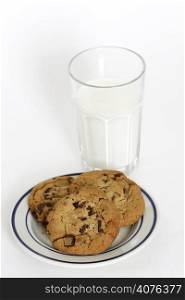 Three chocolate chips cookies and a glass of milk