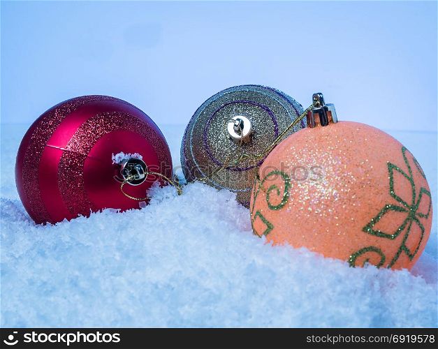 Three Christmas tree with colorful balls on snow