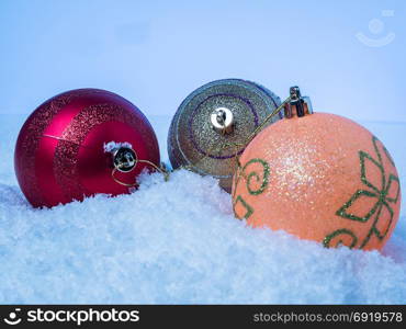 Three Christmas tree with colorful balls on snow