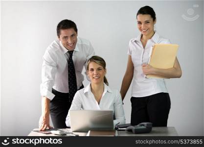 Three co-workers in office