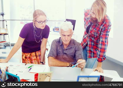 Three co-workers working together. Business team working together in office