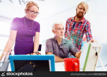 Three co-workers working together. Business team working together in office