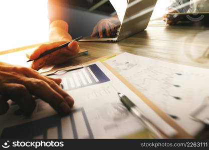 three colleagues interior designer discussing data and digital tablet and computer laptop with business document on wooden desk as concept