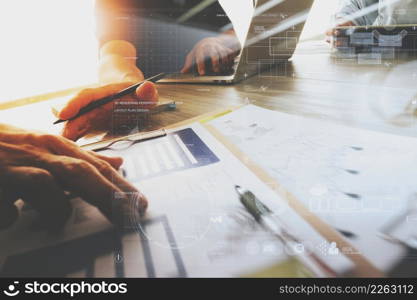 three colleagues interior designer discussing data and digital tablet and computer laptop with business document and digital design diagram on wooden desk as concept